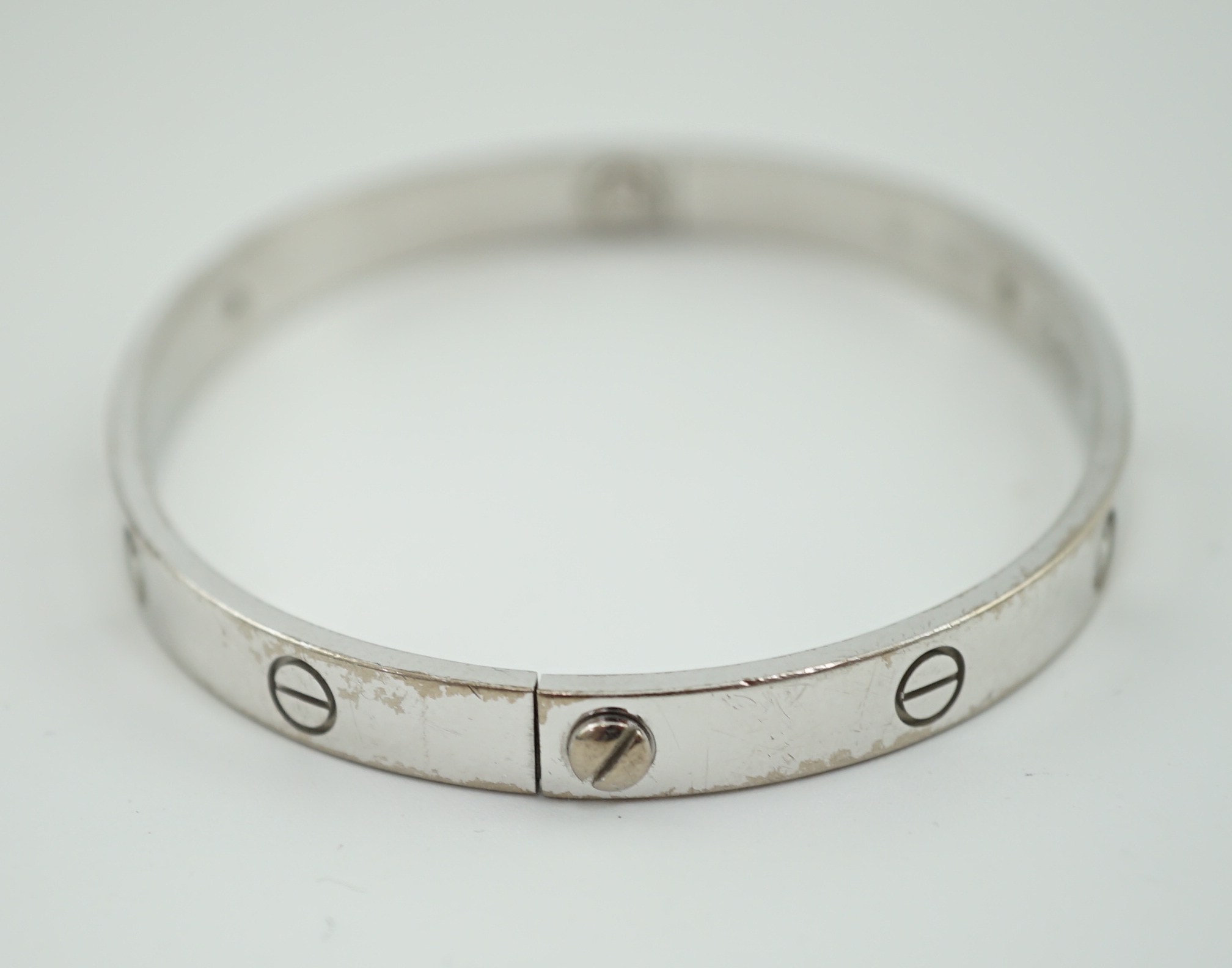 A modern Cartier 750 white gold and four stone gypsy set diamond 'Love' bangle